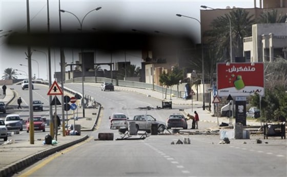 An impromptu roadblock is seen through a car windscreen in Tripoli, on Saturday.