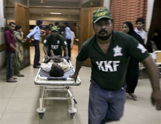 A shooting victim is brought to a local hospital in Karachi, Pakistan on Saturday. Gunmen have killed at least 21 people in Karachi in the past 24 hours, raising tensions in Pakistan's largest city as voters headed to the polls Sunday to elect a replacement for a provincial lawmaker assassinated earlier this year.