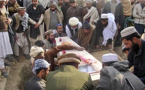 Pakistani relatives and mourners gather around the coffin of a police officer who died Wednesday in a suicide attack in Bannu, during his funeral procession in Lakki Marwat, Pakistan, on Thursday. A suicide car bomber on Wednesday killed many people in an attack on a police station and adjoining mosque in the northwest, showing the threat militants pose there despite repeated offensives by the Pakistani army over the last 2 1/2 years.
