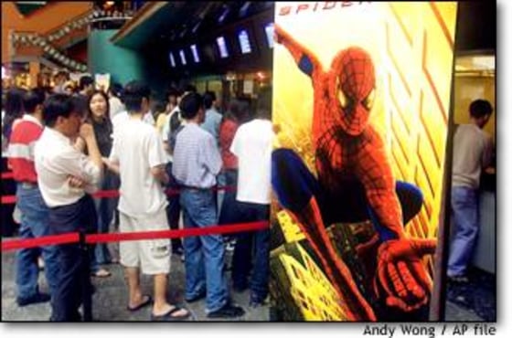 Malaysians wait in a line to see "Spider Man" at a cinema in Kuala Lumpur on April 30. Many interviewees gave the United States high marks on its films.