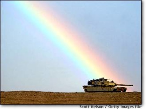 A rainbow breaks over an American M1/A1 Abrams tank during exercises last month near the Iraqi border in Kuwait. The realities of war are seldom this pretty.
