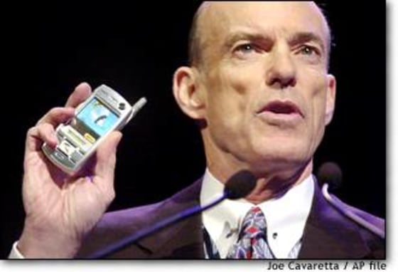 Sprint Corp. Chairman and CEO Bill Esrey holds a Sanyo phone at last year's Consumer Electronics Show in Las Vegas. Sprint ousted Esrey and another top executive after the IRS questioned their efforts to shelter stock options from taxes.