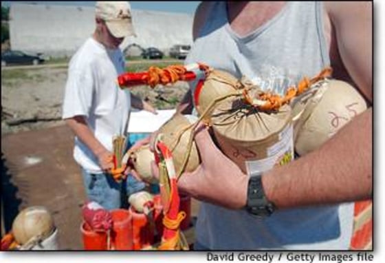 Workers ready a 1,264-shell fireworks show in Burlington, Iowa, along the Mississippi River. About 90 percent of all holiday displays are fired with volunteer help.
