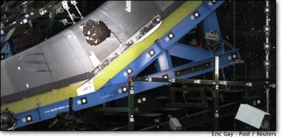 Flecks of debris can be seen within a hole in a reinforced carbon-carbon panel after a 1.67-pound piece of foam insulation was shot at the panel, during a test in San Antonio on Monday.
