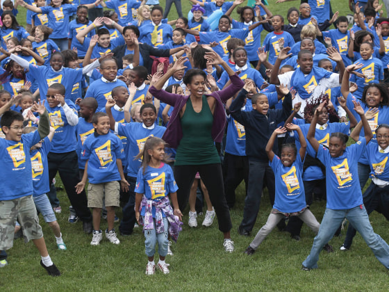 First lady Michelle Obama hosts local children on the South Lawn of the White House in Washington, Tuesday, Oct. 11, 2011, as they attempt to break the Guinness World Records title for the most people doing jumping jacks in a 24-hour period. (Photo by...