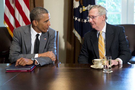 President Barack Obama talks to U.S. Senate Republican Leader Mitch McConnell (R-Ky.) during a meeting with members of Congress in Washington, D.C. on July 31, 2014. (Photo by Andrew Harrer/Picture-Alliance/DPA/AP)