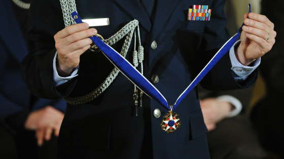 A military aide holds a medal during the Presidential Medal of Freedom ceremony at the White House on Nov. 20, 2013 in Washington, DC.