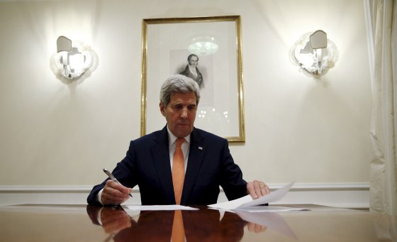 Secretary of State John Kerry signs the certification to the U.S. government that  IAEA certified Iran's compliance in their report, requesting the lifting of the nuclear-related sanctions, Vienna, Jan. 16, 2016. (Photo by Kevin Lamarque/Reuters)