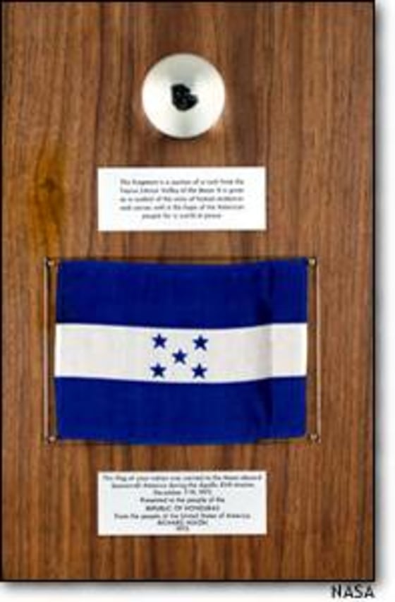A chip from an Apollo-17 moon rock is mounted on a plaque with the Honduras flag in this image taken at the time of the original presentation.