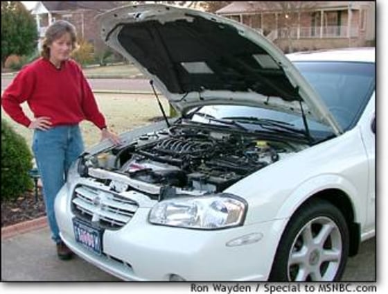 Linda Wayden stands beside the 2001 Nissan Maxima she and her husband purchased through eBay Motors, a car that had been involved in a serious accident and was in worse condition than advertised.