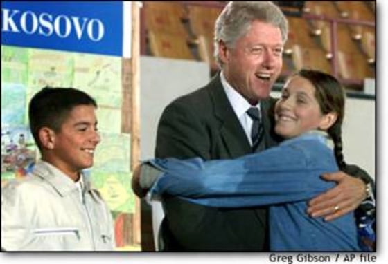 President Clinton hugs a young ethnic Albanian student during his post-war visit to Kosovo in 1999.