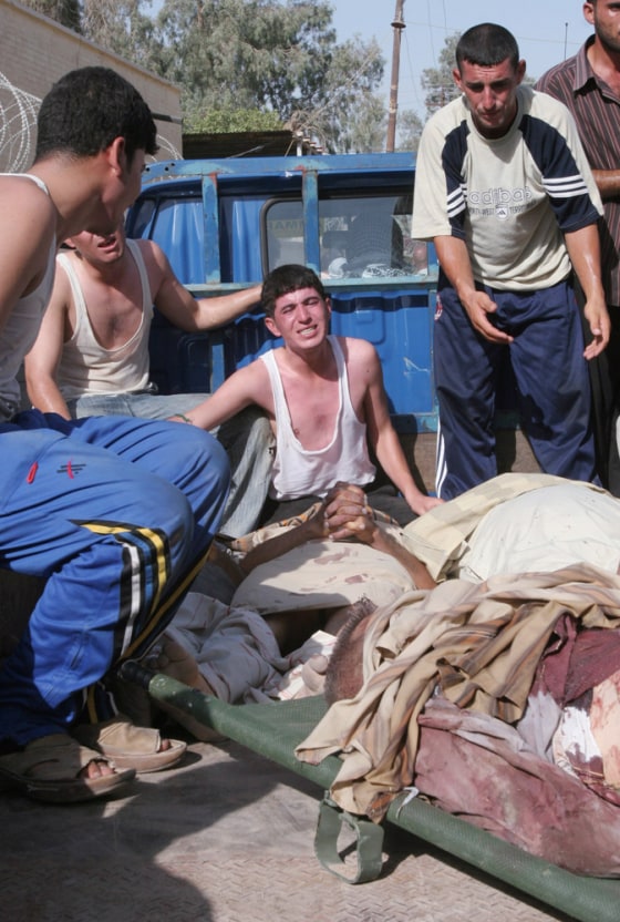Family members identify bodies on Wednesday in Muqdadiyah, Iraq, after gunmen stormed a bus station northeast of Baghdad and killed Shiites.