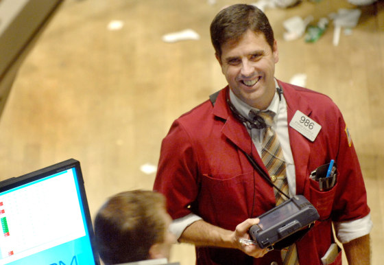 Image: Stephen Guilfoyle of Credit Suisse First Boston smiles as he looks at a monitor