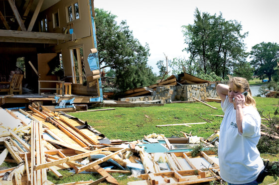 Melissa Tucker talks on her cellphone after a tornado ripped through a resort outside of Town Creek, Ala., on Thursday.