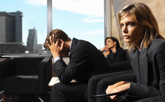 Two Women and a Man Waiting in an Office