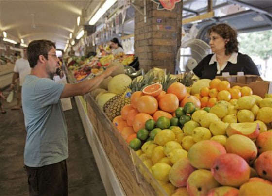 A man shops for fruit at a stand at the West Side Market in Cleveland, Wednesday, July 16, 2008. Food prices showed a big increase in June, rising by 0.7 percent, more than double the 0.3 percent increase of May. Vegetable prices shot up by 6.1 percent, the biggest increase in nearly three years.