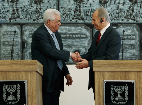 Image: Israel's President Peres shakes hands with Palestinian President Abbas in Jerusalem