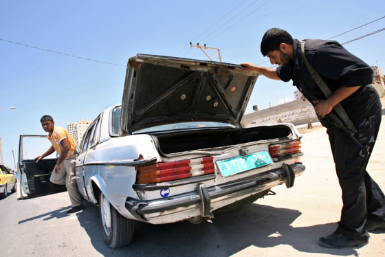 Hamas security forces inspect cars in Gaza City on Sunday.