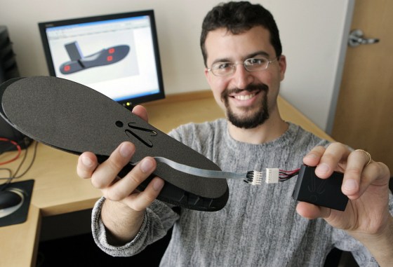 Image: Erez Lieberman displays an \"iShoe\" insole