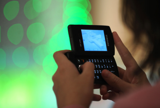 Image: A woman takes a mobile phone photograph