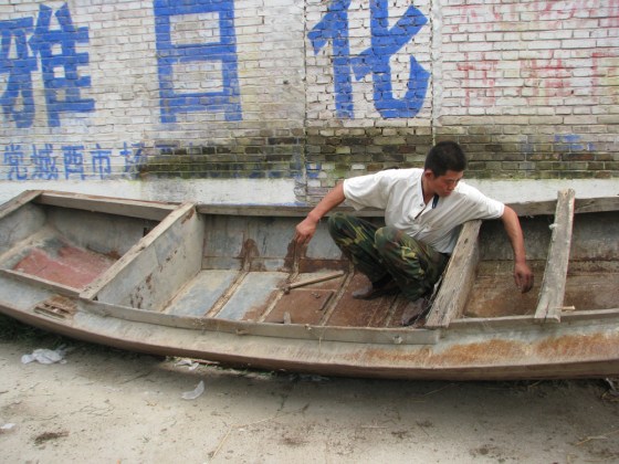 Cheng Linpeng, 34, a migrant worker in Beijing had to leave the city on July 20 because his project was shut down due to pollution concerns ahead of the Olympic Games. He's returned to his hometown of Zhengjiazhuang and is trying to repair an old boat that he hasn't used in several years because all the waterways near his house have dried up.