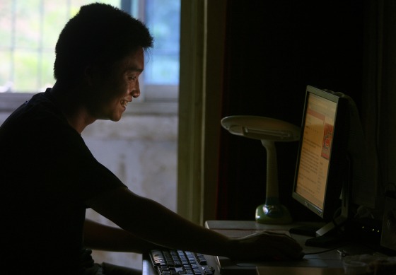Image:Zhang Heng, a blogger surfs the internet at his home