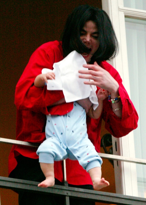 Image: Michael Jackson holds a child out of a window at a Berlin hotel