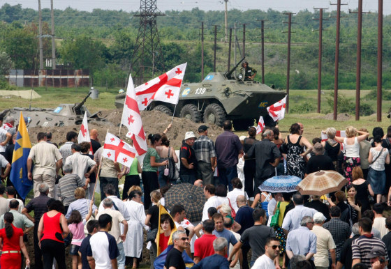 Thousands of Georgians angry at the presence of Russian troops took to the streets in protest Saturday on the outskirts of Poti,&nbsp;a strategic Black Sea port city.