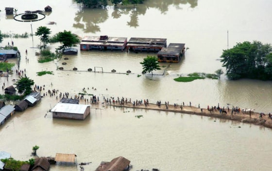 Image: Residents wade through flood water in Saharsa village near river Koshi