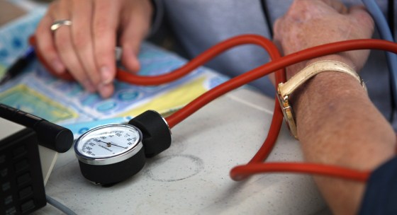 Image: A nurse checks a patient's blood pressure