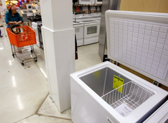 Image: A shopper passes a freezer