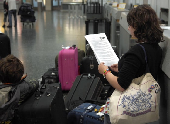 Image:A  passenger holding a statement provided by Zoom Airlines