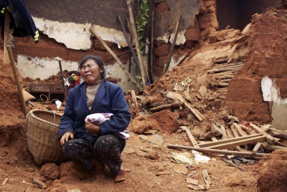 Image: Li Fucui cries in front of the debris of her collapsed house after an earthquake hit Lixi town of Huili County