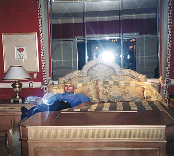 Robert Soloway lays on a bed in a Las Vegas hotel room during his days as a a high-flying spammer.