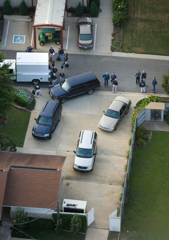 FBI agents execute a search warrant at a residence inside of the Tony Alamo Ministries compound Saturday evening in Fouke, Ark.