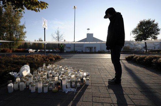 Image: A teenager looks at candles at dawn at the Kauhajoki vocational high school in Kauhajoki, southwestern Finland