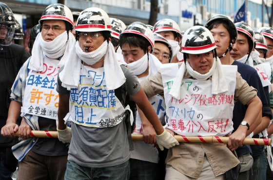 Image: Protestors march against the deployment of USS George Washington