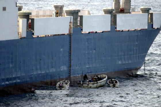 Image: Somali pirates in small boats are seen alongside the hijacked \"Faina\".