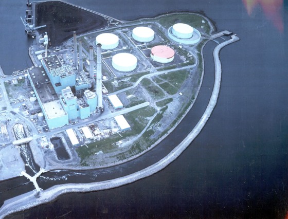 The Brayton Point Station power plant in Somerset, Mass., is one of hundreds across the U.S. that takes in river water to cool steam, in the process sucking in fish. The narrow channel seen here is discharge water. The plant's owner last December agreed to build cooling towers that will reduce the need for river water.