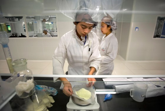 A Chinese worker checks ingredients in milk products in a lab of Yili Industrial Group Co., one of China's largest dairy producers, in Hohhot, north China's Inner Mongolia region, on Oct. 16.