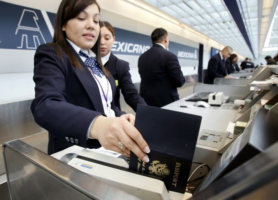 Image: An Mexicana Airlines agent checks a passsport