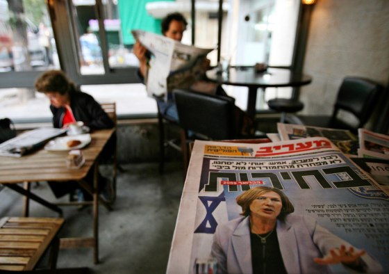 A copy of the newspaper Maariv shows Prime Minister-designate Tzipi Livni at a cafe in Jerusalem on Sunday. Livni on Sunday abandoned her efforts to form a new coalition government and said she would recommend early parliamentary elections. The Hebrew text on the newspaper reads, "Elections."