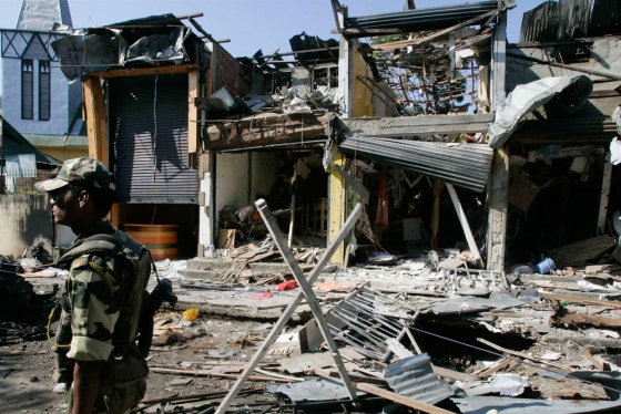 Image: A paramilitary soldier stands guard at the site of an explosion