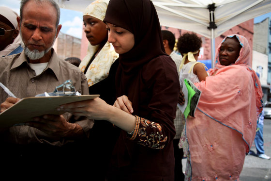 Faiza Ali, center, from the Council on American-Islamic Relations, helps Muslims register to vote in Brooklyn.