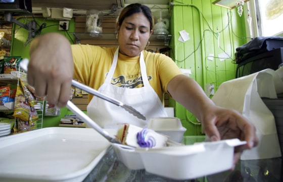 Marcelina Neria Ceniceros works in her bakery, on Tuesday, July 24, in Marshalltown, Iowa. Several Democratic presidential hopefuls have said they are focusing on Iowa Hispanics, arguing that the small but growing population could be a key in determining the top finishers in the state's precinct caucuses.