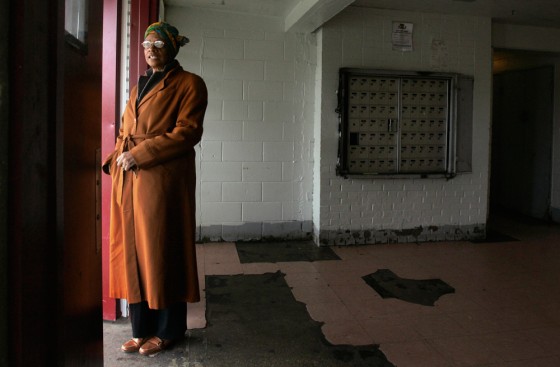 Image: Jacqueline Thompson looks out from the lobby of the building at the Harold Ickes Homes public housing project just south of downtown Chicago.