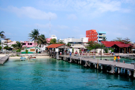 Isla Mujeres, a tiny island mere miles from the Yucatan coast, feels a world away from Cancun's garish hustle and bustle. Instead of the chain restaurants and mammoth resort hotels of neighboring Cancun, Isla Mujeres, though also thriving in its own tourism, manages to maintain the feeling of a small fishing village.