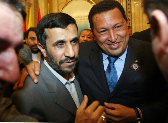 Image: Iranian President Mahmoud Ahmadinejad (L) stands with his Venezuelan counterpart Hugo Chavez