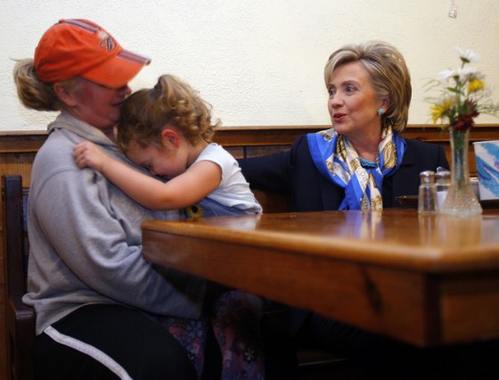 Four-year-old Carly hides her face while her mother talks to Democratic presidential candidate U.S. Senator Clinton in Exeter