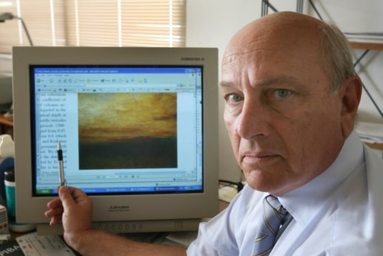 Image: Greek scientist Christos Zerefos shows one of the paintings that he studied